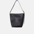 Black handbag with a gold zipper on a light gray background
