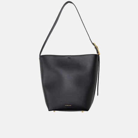 Black handbag with a gold zipper on a light gray background
