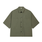 Green short-sleeve shirt with button details on a white background