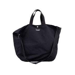 Black tote bag with shoulder strap on a white background