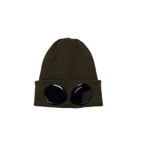 Green beanie with black circular eyelets on a white background