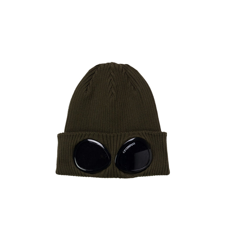 Green beanie with black circular eyelets on a white background