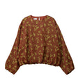 Rust colored blouse on a white background