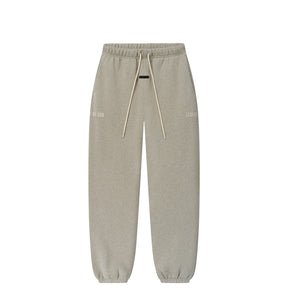 A pair of light gray heather sweatpants with an elastic waistband, matching drawstrings, and subtle tonal text graphics on the upper thighs, shown against a plain white background.