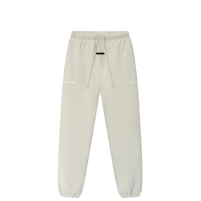 Light beige heather sweatpants with an elastic waistband, beige drawstrings, and subtle white text graphics on the upper thighs, shown against a plain white background.