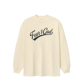 An oversized cream-colored long-sleeve t-shirt with 'Fear & God' printed in black script across the chest, displayed on a clean white background.