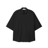 Black button up shirt on a white background