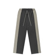 A pair of color-blocked sweatpants in dark gray and light gray, featuring a white drawstring, shown against a plain white background.