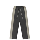 A pair of color-blocked sweatpants in dark gray and light gray, featuring a white drawstring, shown against a plain white background.