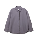 Gray shirt with ruffled front panel on a white background