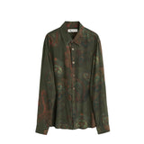 Green patterned shirt on a white background