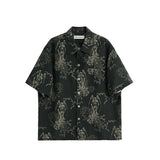 Black short-sleeve shirt with intricate white patterns on a white background