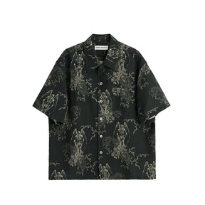 Black short-sleeve shirt with intricate white patterns on a white background