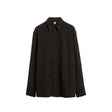 A black long-sleeve button-up shirt with a pointed collar, displayed flat against a solid white background.