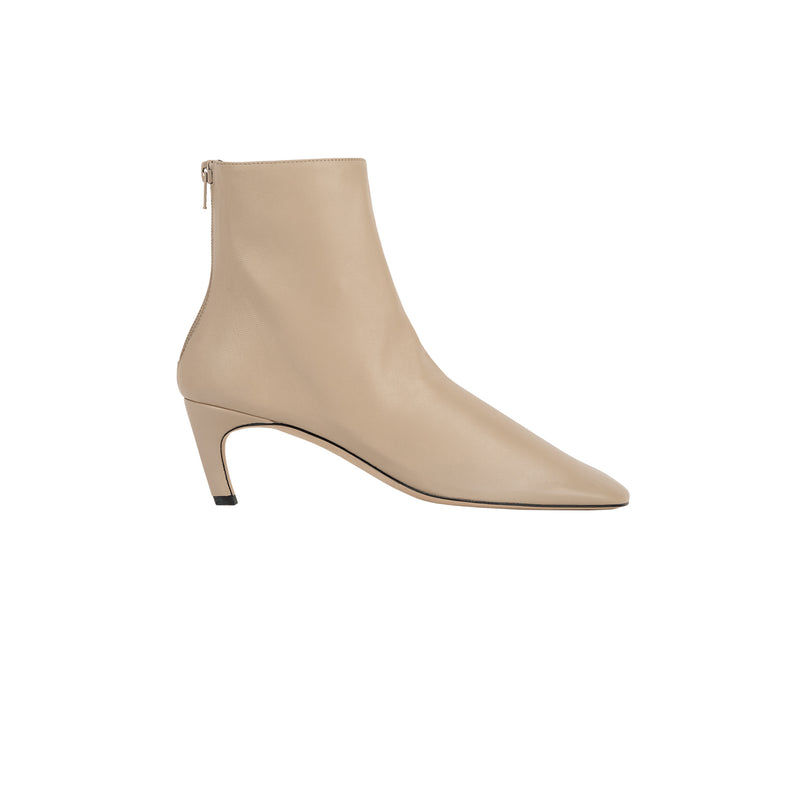 A single beige leather ankle boot with a pointed toe and a slim kitten heel, shown from a side profile on a solid white background.
